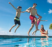 Family jumping into pool at Sunscape Resorts & Spas